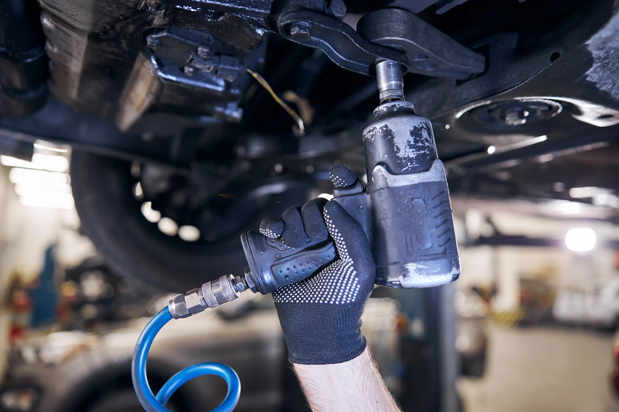 car-mechanic-using-impact-wrench-at-auto-repair-st-2024-10-21-12-59-47-utc